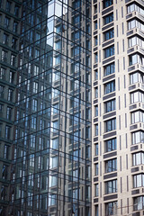 Fototapeta premium Modern skyscrapers with reflection in windows, background with blue textures