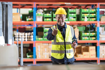 Male employee using a radio in the warehouse.