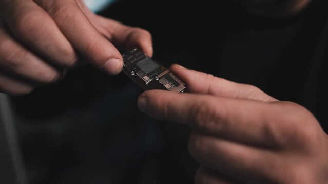 Man Engineers Fixing Smartphone Broken Screen Lots Of Close-ups B-roll. Fixing Process In Repair Shop - Repairman Working With Broken Mobile Phone, Special Tools On Workplace.