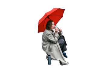 A lone woman under a red flag drinks tea from a thermos on the cold steps, isolated on a white background