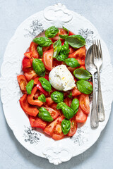 Tomato, bell pepper, mozzarella and basil Salad. Healthy mediterranean food. Appetizing dish. Top view.