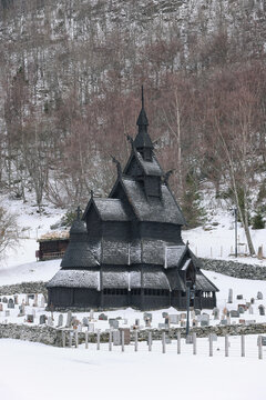 Architecture of the famous Landmark Stavkirke An Old Wooden Triple Nave Stave Church In Summer Day. Ancient Old Wooden Worship In Norwegian Countryside Landscape.