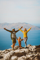 Family hiking in Greece parents with child travel outdoor mother and father raised hands active summer vacations healthy lifestyle eco tourism in Rhodes island mountain top - 580803601