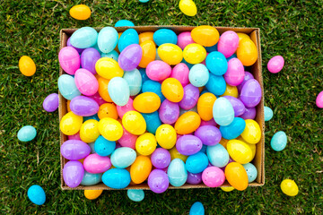 Box full of colorfull easter egg treats for children for egg hunting