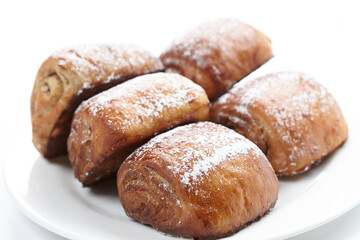 buns with poppy seeds on white background