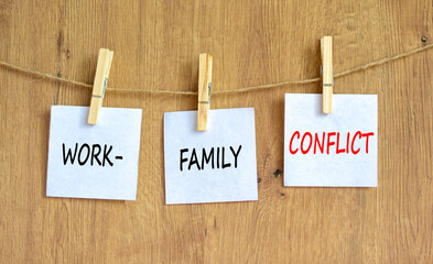 Work-family conflict symbol. Concept words Work-family conflict on white paper on wooden clothespin on a beautiful wooden table wooden background. Business work-family conflict concept. Copy space.