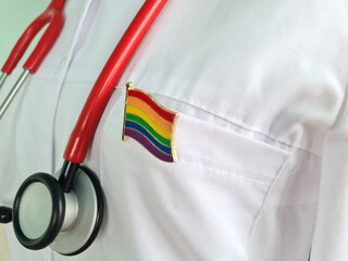 Silhouette of doctor in white coat with stethoscope and LGBT badge on pocket