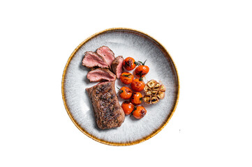 Roasted Lamb tenderloin meat in plate with grilled tomato and garlic, mutton sirloin fillet steak. ...
