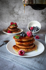 
Pancakes with berries. breakfast. On a concrete background
