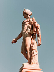 Statue of Apollo, ancient Greek god of fine arts, wearing a tunic and holding a lyre. Travel to...