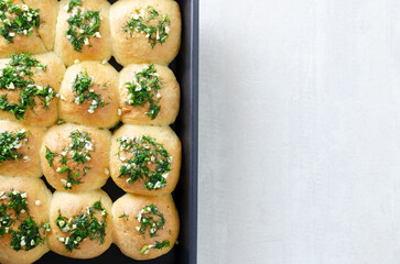 Buns with garlic and dill sauce with oil. Preparation of pampushky (Pampushky), traditional Ukrainian buns for borsch. The concept of traditional dishes. Homemade baking. Top view. Copy space