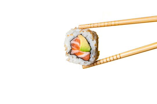 Salmon uramaki grabbed by wooden chopsticks with trasparent background