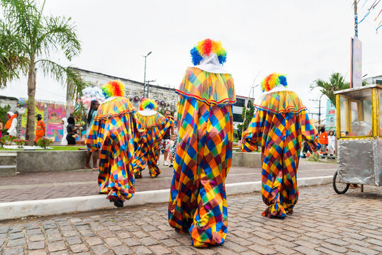 People dressed as clowns are seen parading during the carnival in the city of Maragogipe.