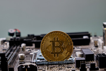 Close-up of a Bitcoin on top of a bunch of electronic circuits.