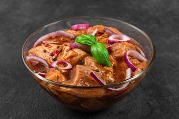 Raw pork or beef meat in marinade on black background. Cooking food for bbq or barbecue