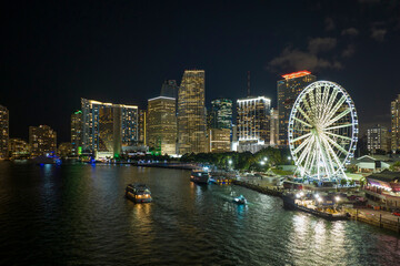 Skyviews Miami Observation Wheel at Bayside Marketplace with reflections in Biscayne Bay water and...