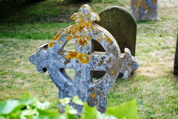 Celtic cross headstone in an ancient European cemetery