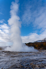 Fototapeta na wymiar Strokkur geyser in southwestern Iceland. Erupting fountain-type geyser in Haukadalur valley on the slopes of Laugarfjall hill, which is also the home to Geysir geyser.