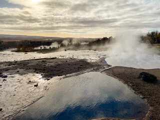 Geysir (The Great Geysir) geyser in southwestern Iceland. Geysir in Haukadalur valley on the slopes of Laugarfjall hill, which is also the home to Strokkur geyser.