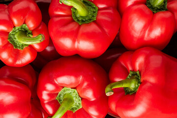 Red sweet pepper in box on old wooden background. Top view