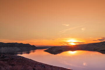 Beautiful sunset over the lake. Panoramic sunset landscape.