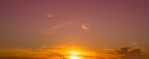 Naklejka na ściany i meble Beautiful bright orange sunset sky with dramatic clouds. Sunset sky with clouds background.