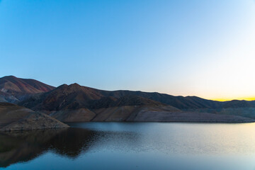 Fototapeta na wymiar Beautiful mountains and lake landscape after sunset. Panoramic sunset landscape.
