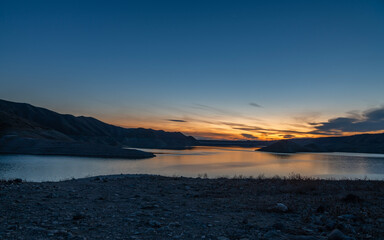 Beautiful sunset over the lake. Panoramic sunset landscape.