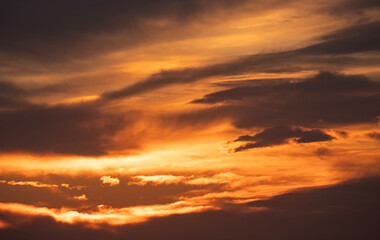 Beautiful bright orange sunset sky with dramatic clouds. Sunset sky with clouds background.