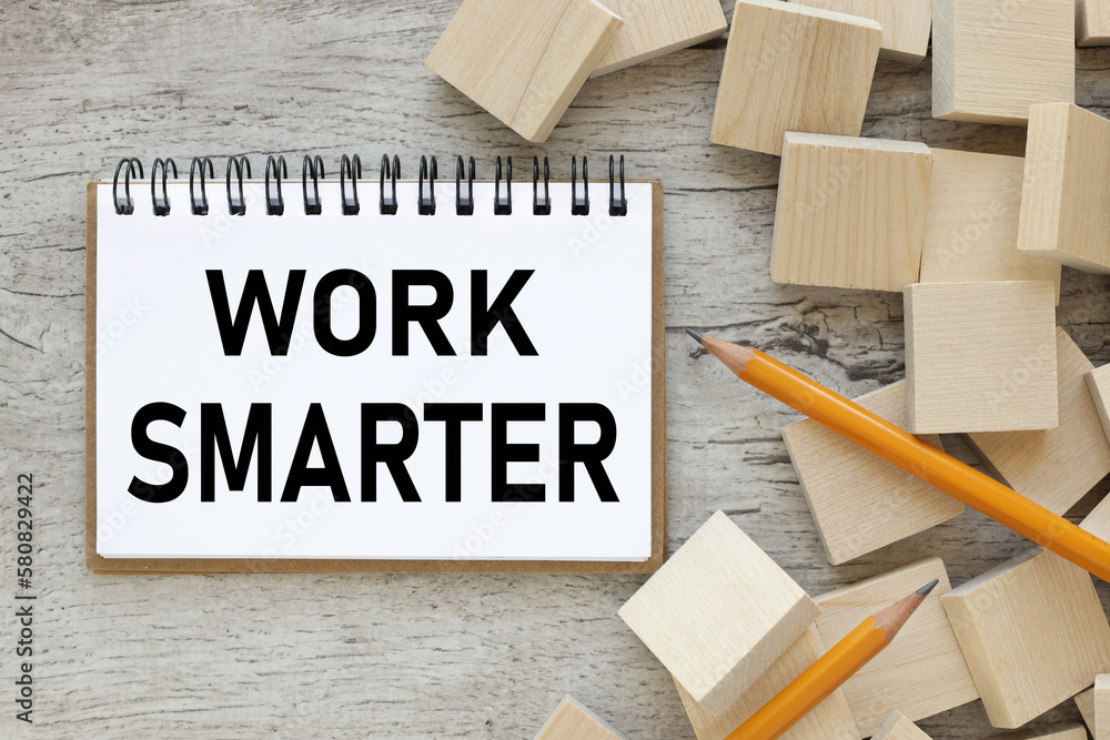 Poster work smarter. open notepad with text near wooden cubes and blocks. self motivation concept.