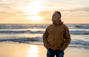 Bearded Man relaxing alone on the seaside on hot sunny day at sunset. Travel  Lifestyle concept