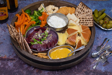 Vegetarian food board consisting of cheese, crackers, cudites