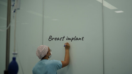 breast implant surgery. Doctor doing breast lift surgery with nurse - obrazy, fototapety, plakaty