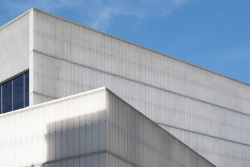 Fototapeta na wymiar Two modern white buildings creating a unique geometry