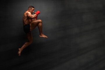 Fototapeta na wymiar Martial Art Fighter Performing Flying Knee Kick