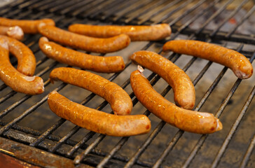 Street food - barbecue sausages on the grill grate