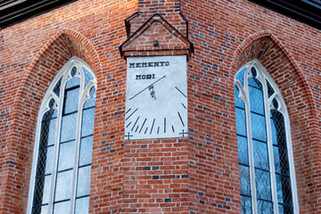 Historical clock on the facade of the monastery. Post-monastery complex. Kartuzy, Poland.