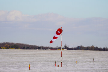 Windsock indicator of wind on runway airport. Wind cone indicating wind direction and force. Fully...