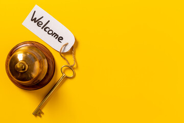 Vintage golden hotel service bell with key