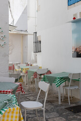 A beautiful view of the tables of a home restaurant in the city of Ostuni.