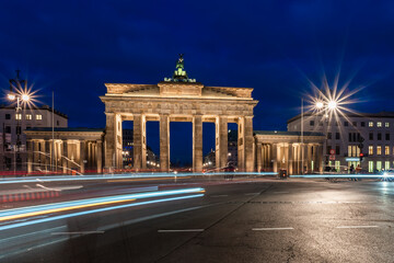Fototapeta na wymiar Traces of light in front of the Brandenburg Gate in Berlin at the blue hour