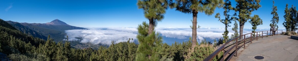 Huge panorama shot of volcano el teide and its surroundings of clouds, trees and nature, in a...