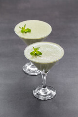 Italian dessert. Mint cream jelly, Panna Cotta in a martini glass. Dark gray background