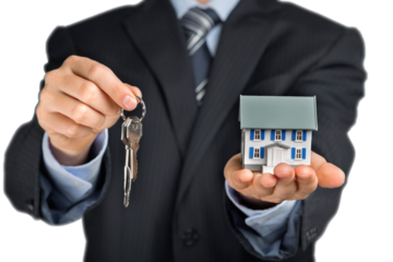 Businessman Holding a Model House and Keys