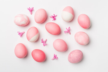 Naklejka na ściany i meble Pink Easter eggs with decor on color background, top view