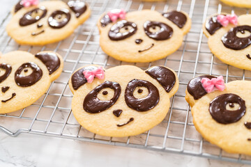 Panda shaped shortbread cookies with chocolate icing