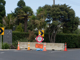 A road has been blocked with a concrete slab.Signs say 'road closed' and 'residents only'. Muriwai.New Zealand.Result of Cyclone Gabrielle.