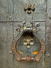 Iron forged door handle close-up. Antique vintage doorknob for knocking on the door