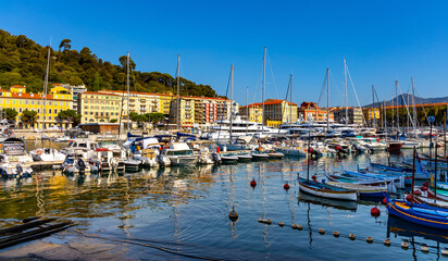 Fototapeta na wymiar Nice port with yachts, boats and pierces in Nice Port and yacht marina district with Colline du Chateau Castle hill on French Riviera in France