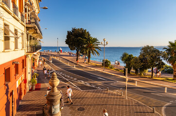 Sunset view of Quai Rauba Capeu promenade aside Colline du Chateau Castle Hill in Nice on French...